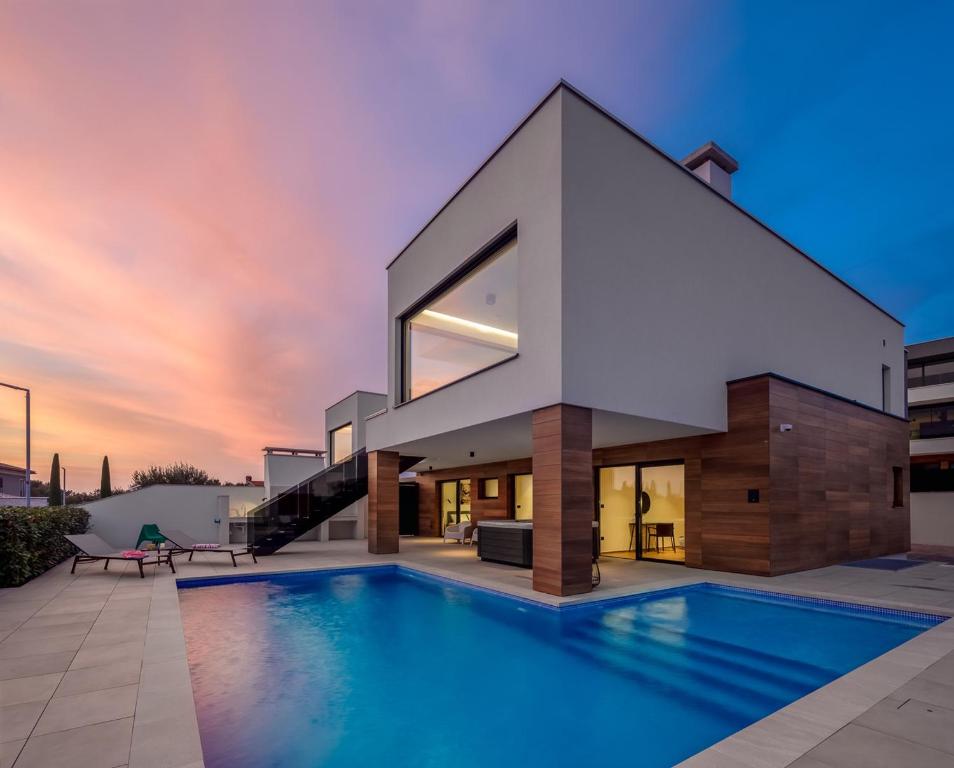 a house with a swimming pool in front of it at Villa Old Olive IV - Heated Pool - by Vivi Rent in Vodnjan