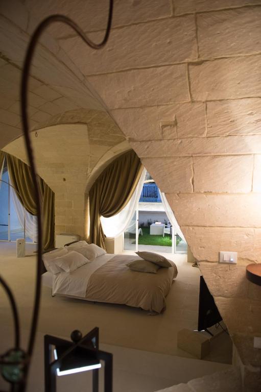 Postel nebo postele na pokoji v ubytování Corte Campanile Boutique B&B