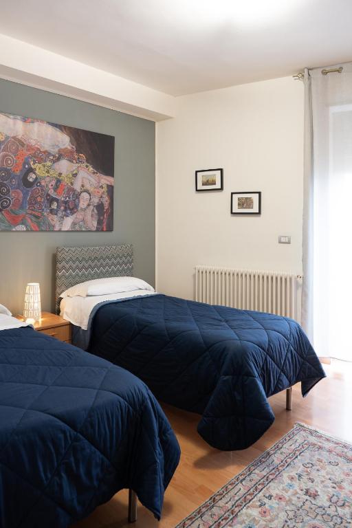 sypialnia z 2 łóżkami i niebieskimi kołdrami w obiekcie B&B Bella Vista w mieście Valguarnera Caropepe