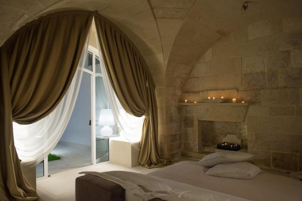 Postel nebo postele na pokoji v ubytování Corte Campanile Boutique B&B