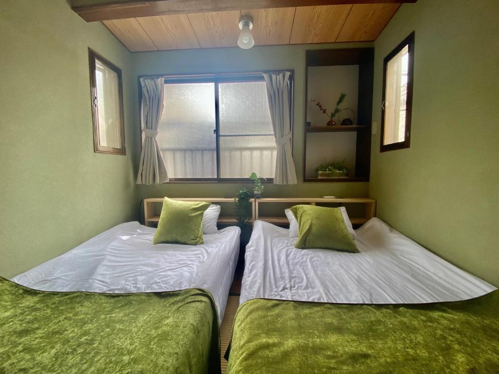 Cama ou camas em um quarto em Momodani 72 two-story detached house