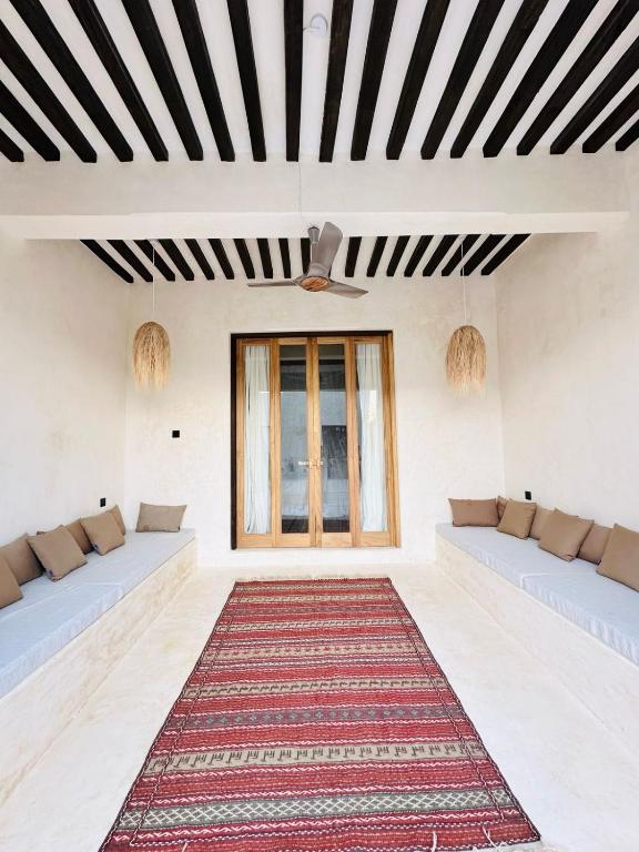 Postel nebo postele na pokoji v ubytování Tulia House Lamu