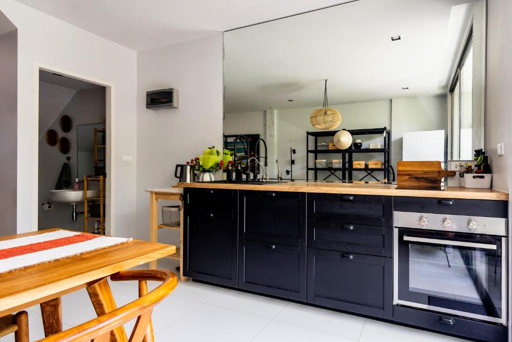 a kitchen with a stove and a counter top at TownHouse6 2BR MonkeyHill in Ban Sam Kong