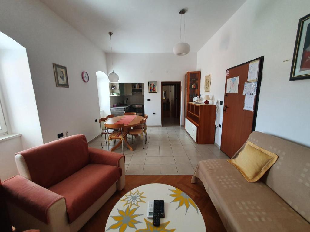 a living room with a couch and a table at Apartment Goga in Cres