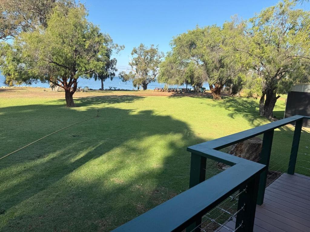 a view of a park from a deck with trees at Waters Edge Retreat in Dawesville