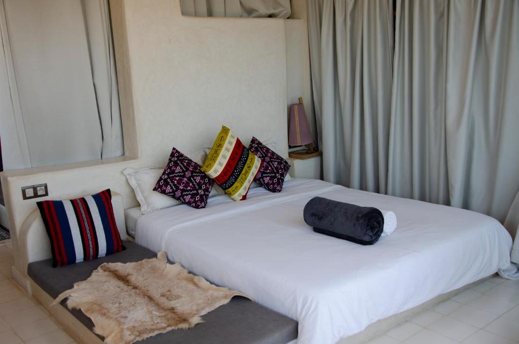 two beds with pillows on them in a room at SurfAppart Morocco in Tamraght Ouzdar