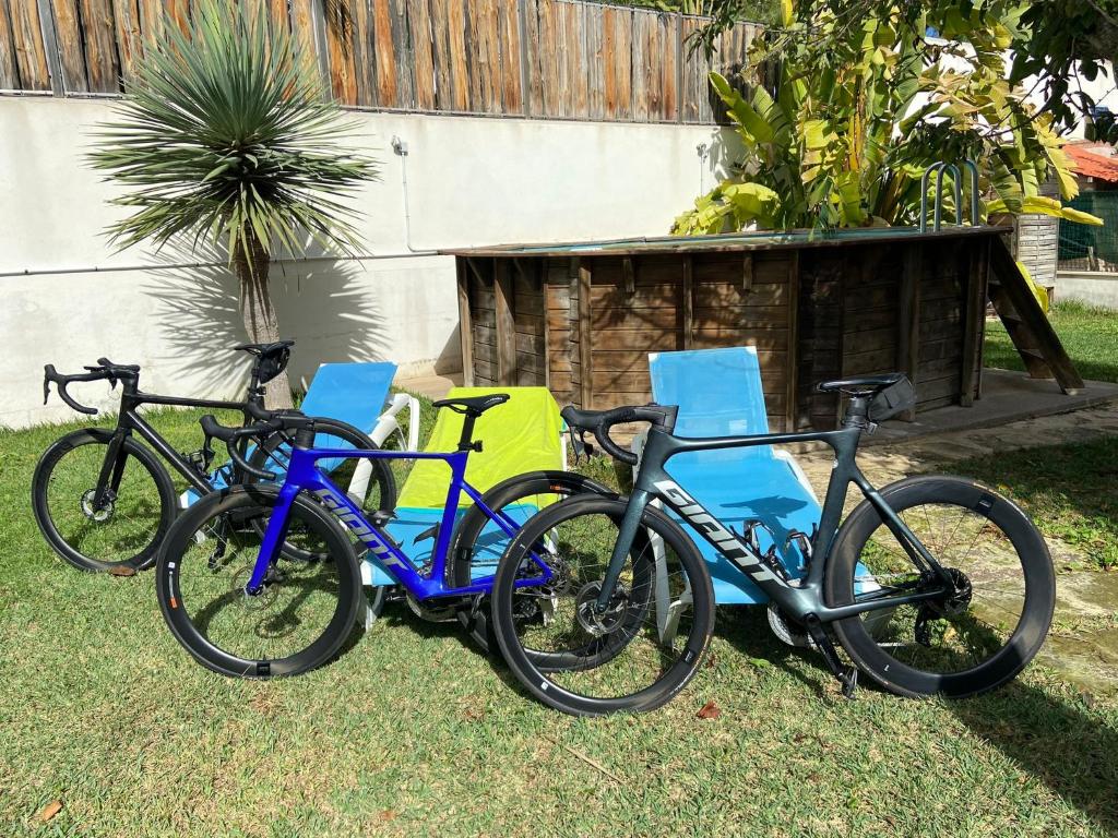 a group of three bikes parked next to chairs at Villa Es Tamarells Blue in Can Picafort