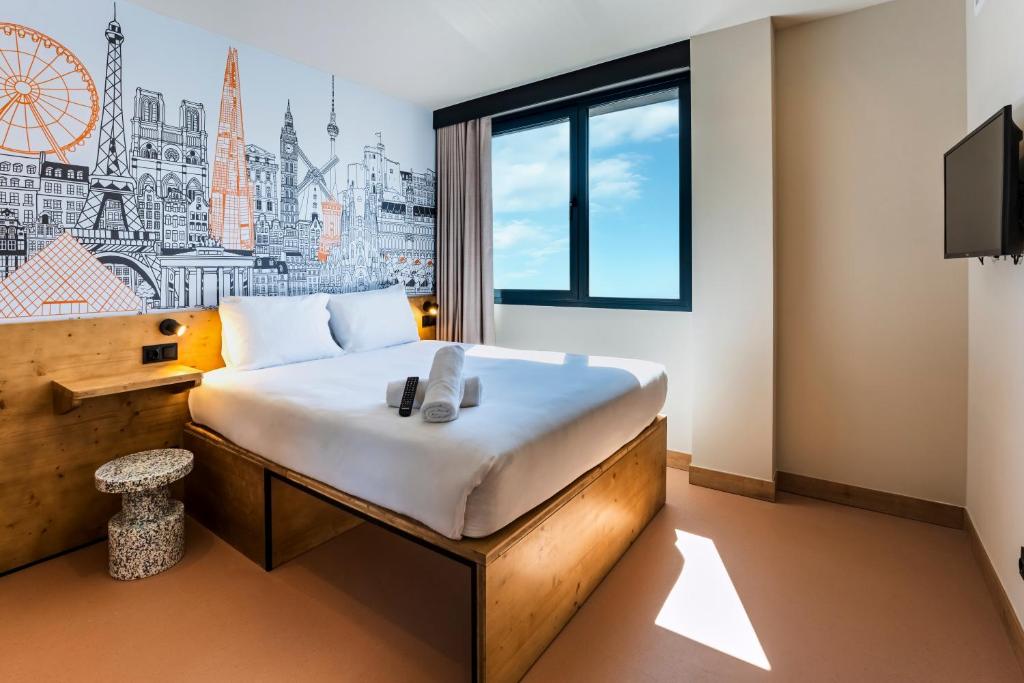 a hotel room with a large bed and a window at easyHotel Barcelona La Sagrera in Barcelona