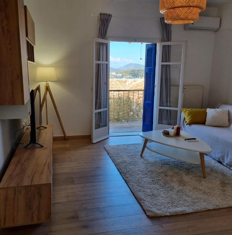 a living room with a couch and a coffee table at MARINA'S HOUSE - Serenity in Poros