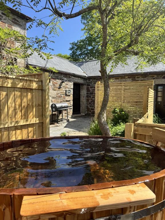 a pond in the backyard of a house at Cobble by Together Travel - Luxury Cornish Countryside Retreat in Bodmin