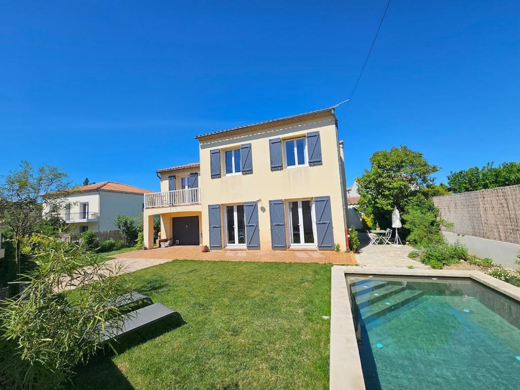une maison avec une piscine dans une cour dans l'établissement Jolie villa avec piscine proche du centre historique, à Arles