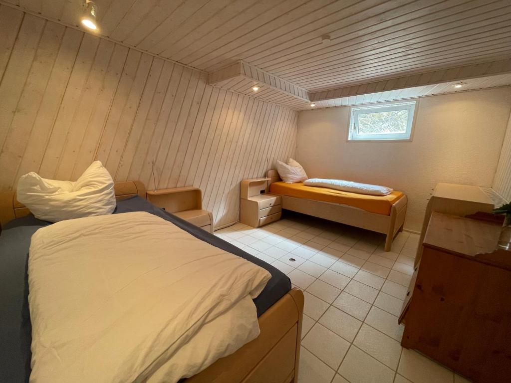 a bedroom with a bed and a bench in it at Dill Apartment Pleinfeld am Brombachsee IV in Pleinfeld