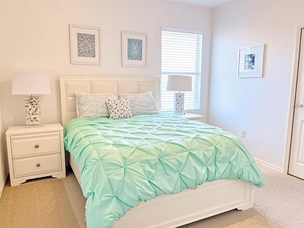 a white bedroom with a bed and two night stands at Spacious King, Queen Rooms in Luxury Villa-Pool-SPA-Disney-WiFi-Smart TV in Davenport