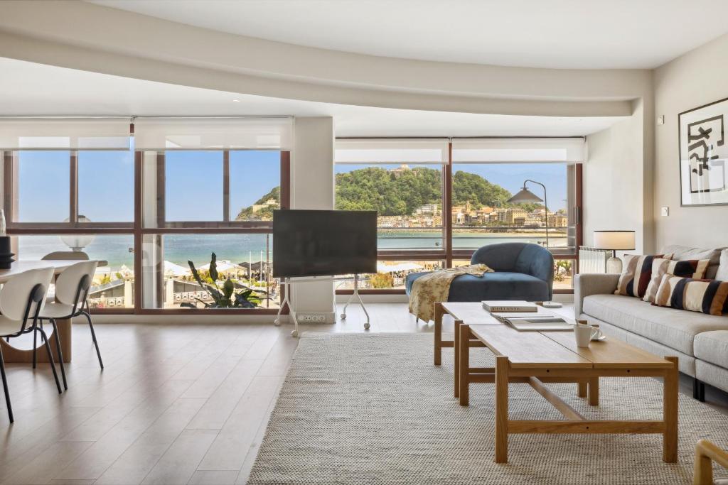 a living room with a view of the ocean at Playa de La Concha 9 by FeelFree Rentals in Donostia-San Sebastián