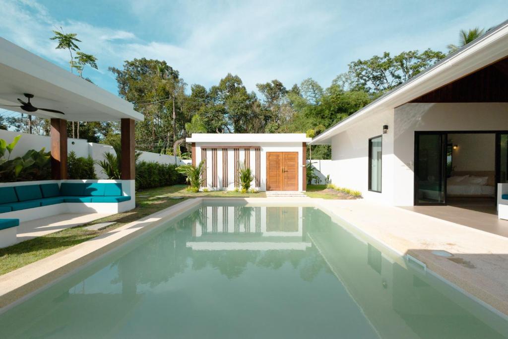 a swimming pool in the backyard of a house at Samui Paradise Poolside Villa in Nathon Bay