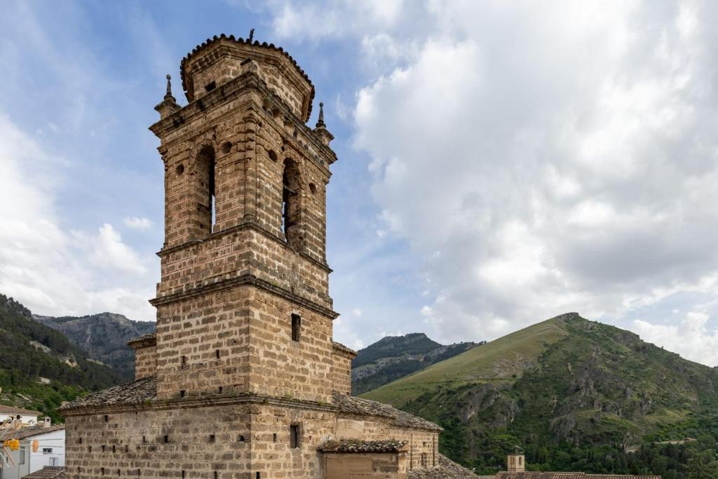 an old brick tower on top of a mountain at Alojamiento el Campanario in Cazorla