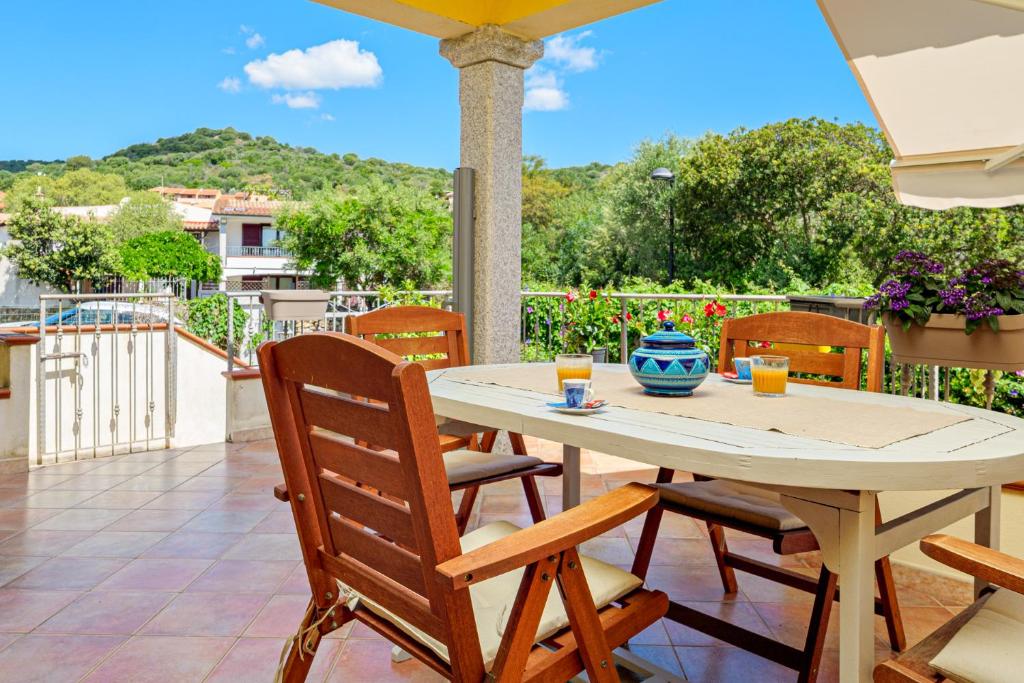 a table and chairs on a patio with a view at Orsa Maggiore Ottiolu in Porto Ottiolu
