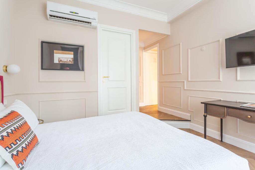 Łóżko lub łóżka w pokoju w obiekcie La Locanda di Piazza del Popolo