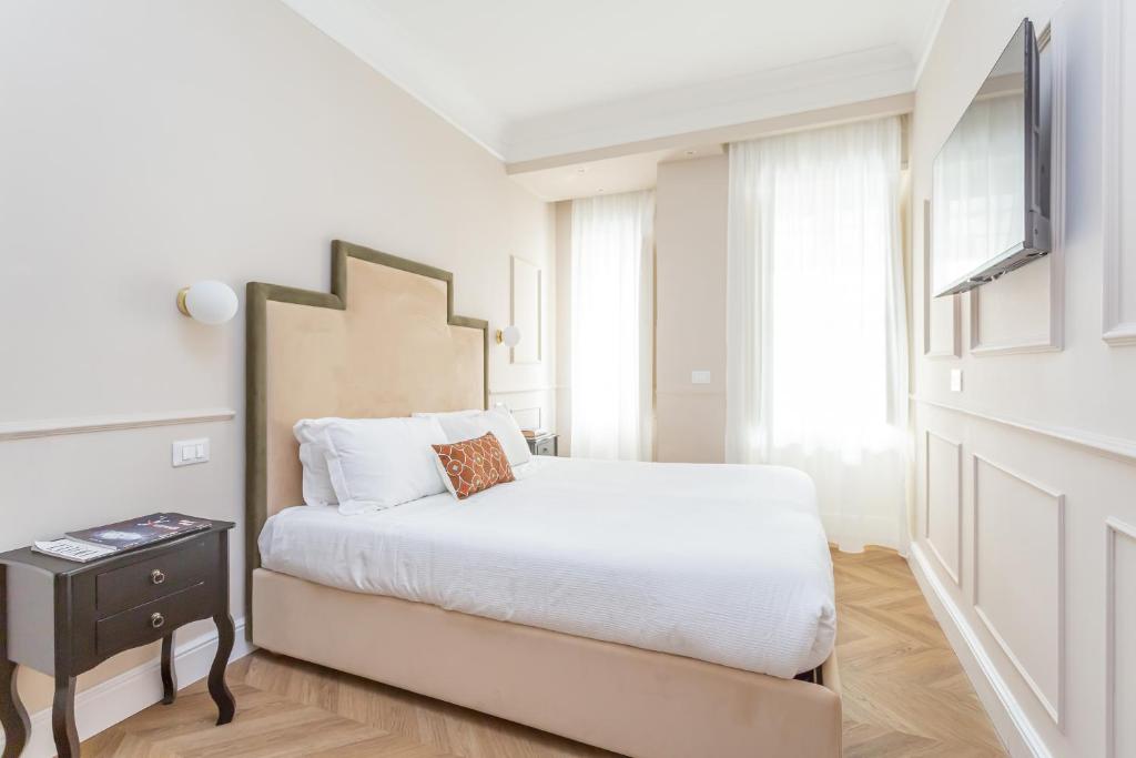 Łóżko lub łóżka w pokoju w obiekcie La Locanda di Piazza del Popolo