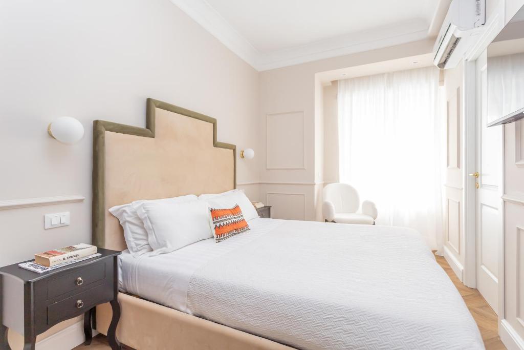 Łóżko lub łóżka w pokoju w obiekcie La Locanda di Piazza del Popolo