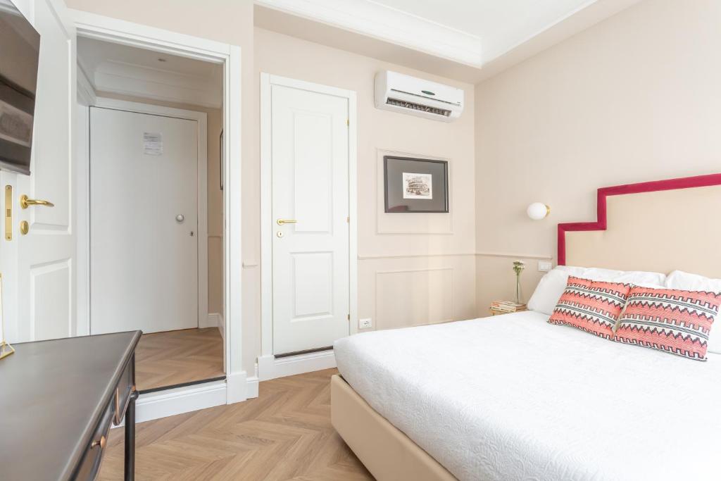 Łóżko lub łóżka w pokoju w obiekcie La Locanda di Piazza del Popolo
