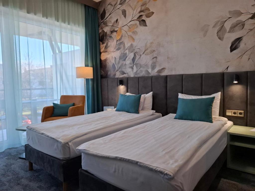 Postel nebo postele na pokoji v ubytování Szépia Bio and Art Hotel