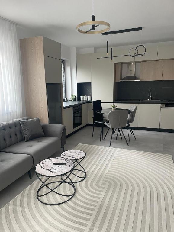 a living room with a couch and a table at Apartament A&Maya in Râmnicu Vâlcea