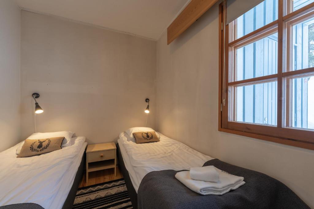 Кровать или кровати в номере Kuukkeli Apartments Saarisatu ja Urupää