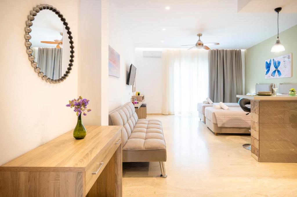 a living room with a couch and a dining room at Diamond Apartments 3 in Kardamaina