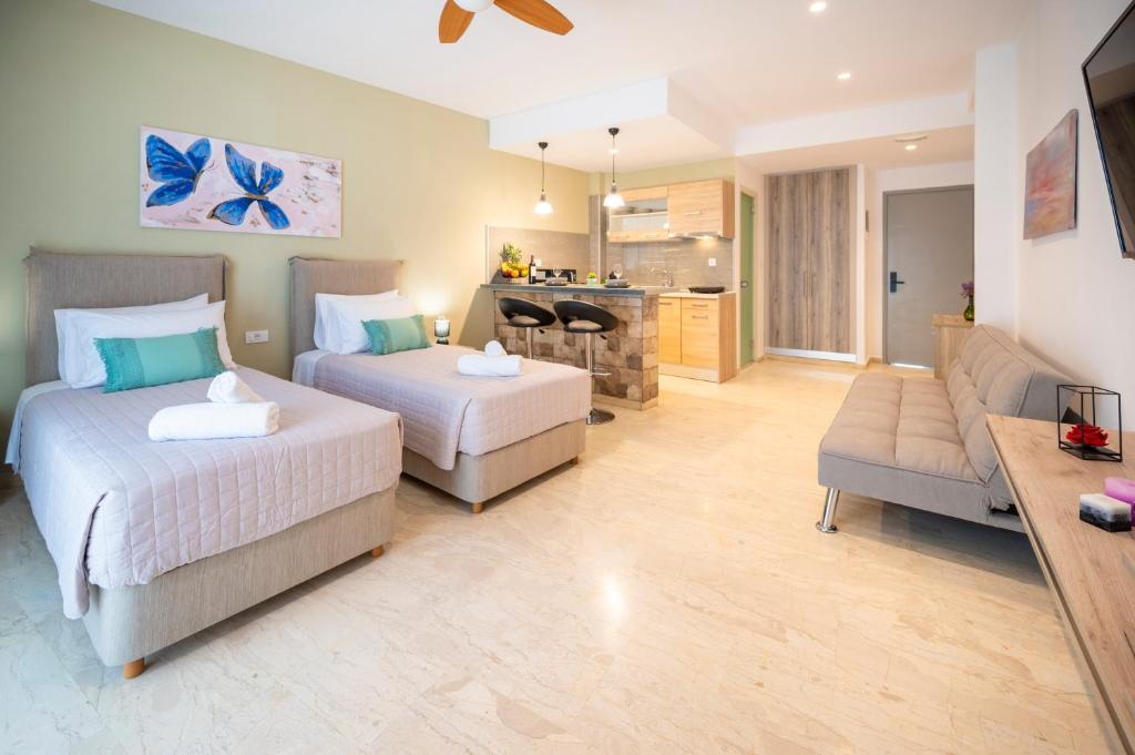 a hotel room with two beds and a living room at Studio with Balcony - 3 min Walk to Beach - Diamond 3 in Kardamaina