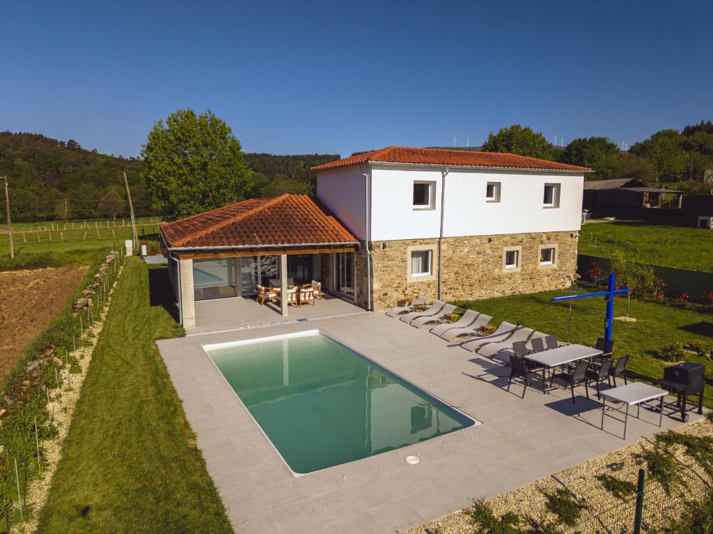 an aerial view of a house with a swimming pool at Reverence Villas Carballal in Palas de Rei