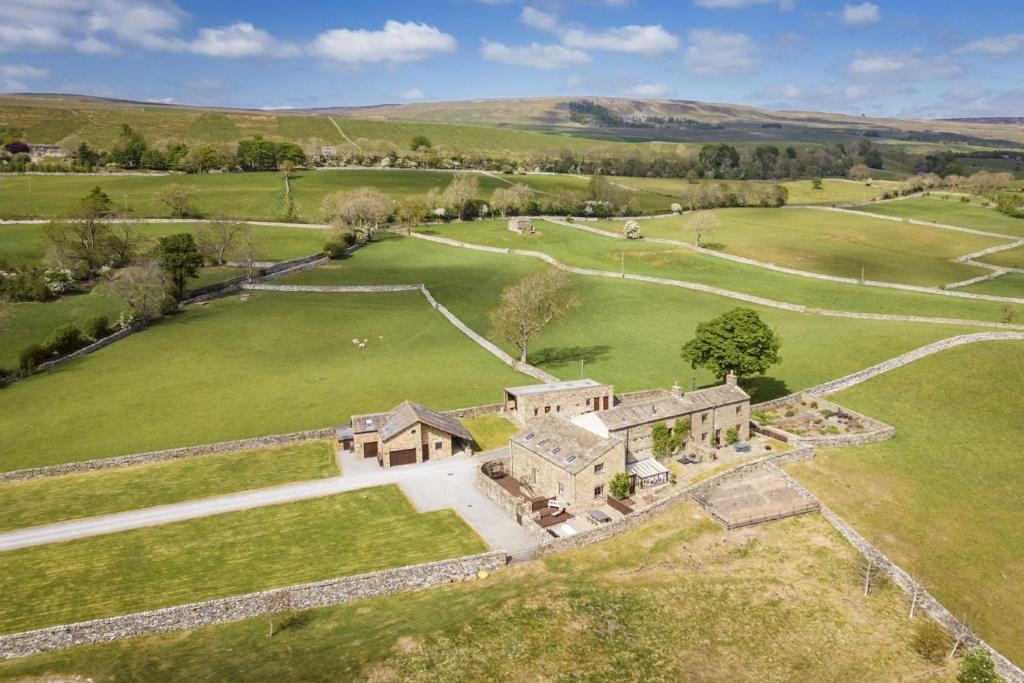 an aerial view of an old house in a field at Hill Top Farm 22 in Bainbridge