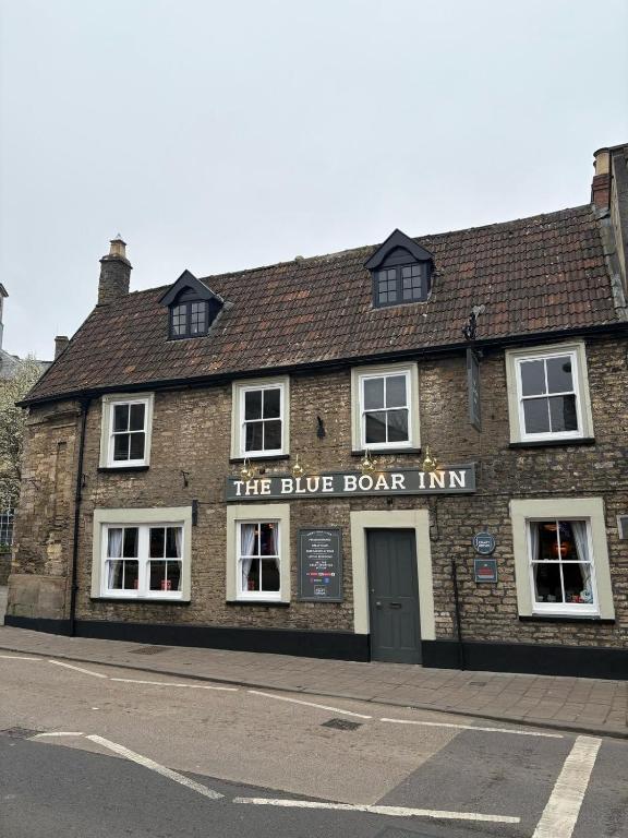 a brown brick building with a blue door inn at Blue Boar in Frome