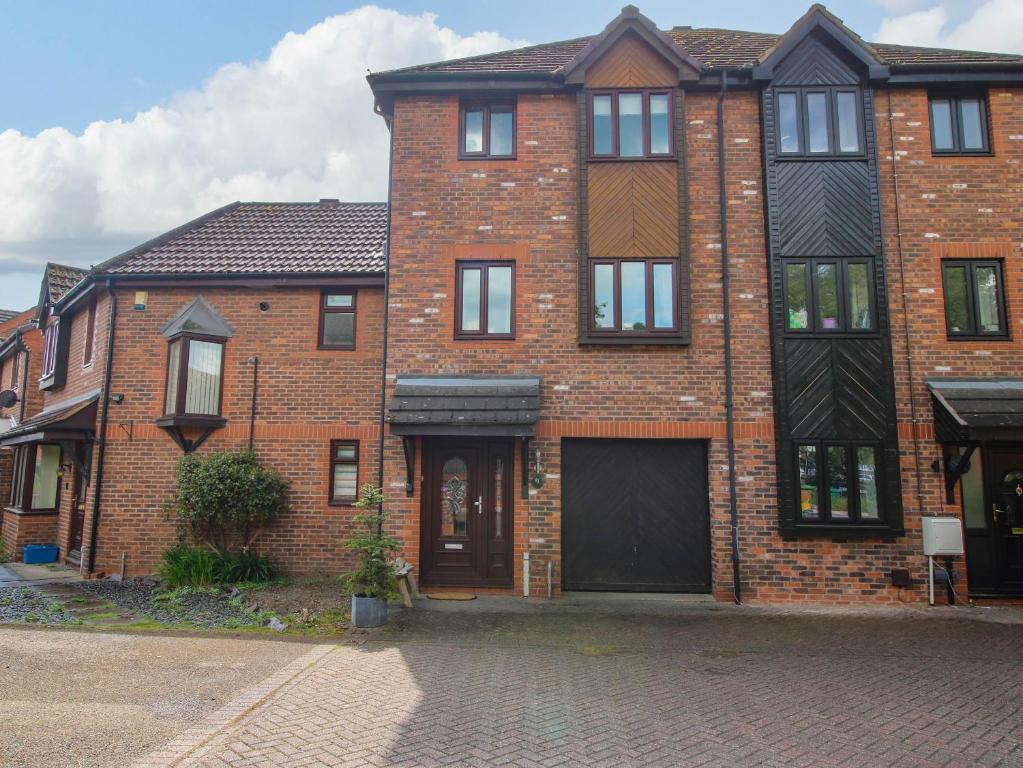 a brick house with a garage on a brick street at 63 Severn Street in Bridgnorth