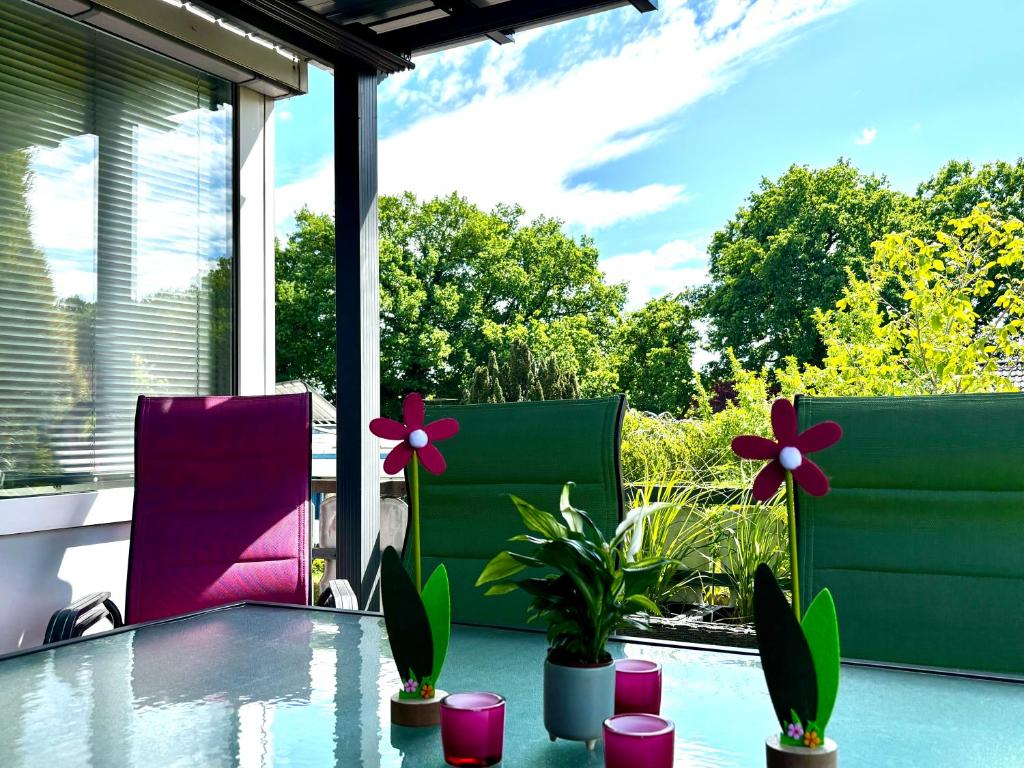 a patio with a table with flowers on it at Ferienwohnung Micaela in Haselünne