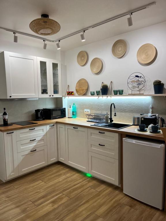 a kitchen with white cabinets and a sink at La Mata Apartment, Spain in La Mata