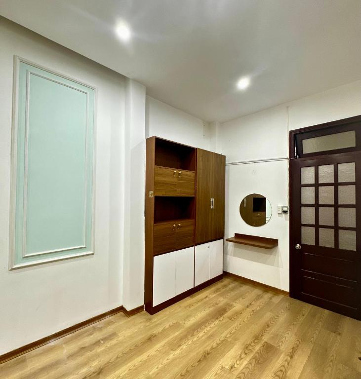 an empty room with a door and a window at Tinahouse in Danang