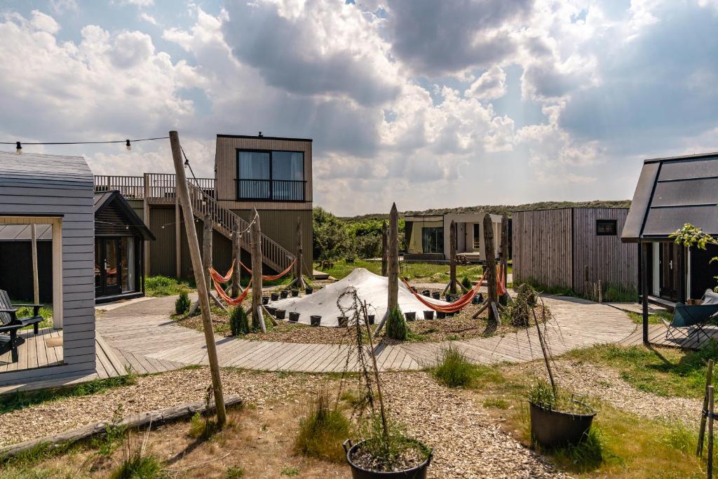 a backyard with a playground with a slide at Basecamp Tiny House Eco-resort IJmuiden in IJmuiden