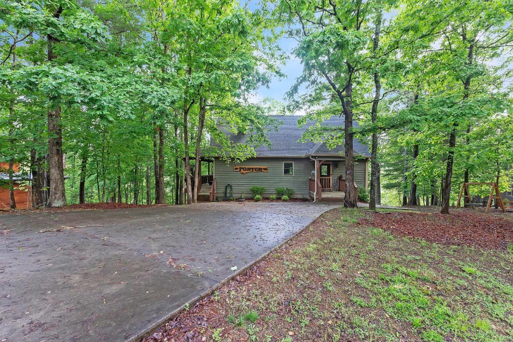 an empty driveway in front of a house with trees at Mountain Getaway with Hot Tub & Game Room cabin in Cleveland