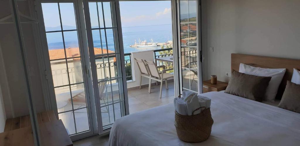 a bedroom with a bed and a view of the ocean at Villa Eleni Greece - wonderful sea view studios in Nea Roda