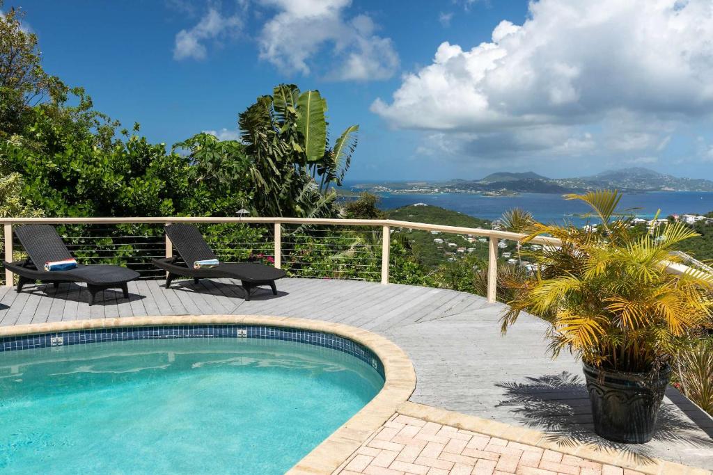a swimming pool on a patio with a view of the water at Cielo Vista Villa 3 BDRM Sleeps 6 Heavenly View in Cruz Bay