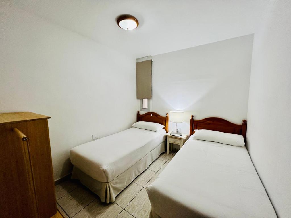A bed or beds in a room at Apartamentos Frontera