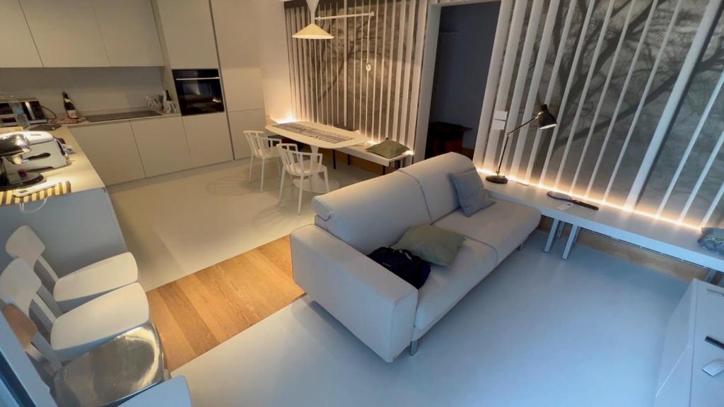 a living room with a white couch and a table at Alessandra House in Grottammare