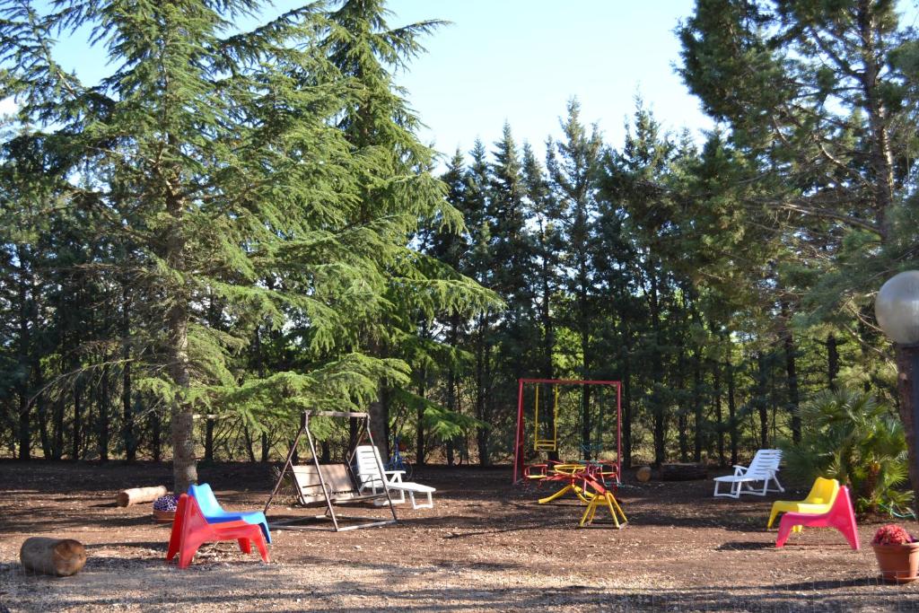 a playground with colorful chairs and a swing set at B&B Le Stagioni in Castel del Monte