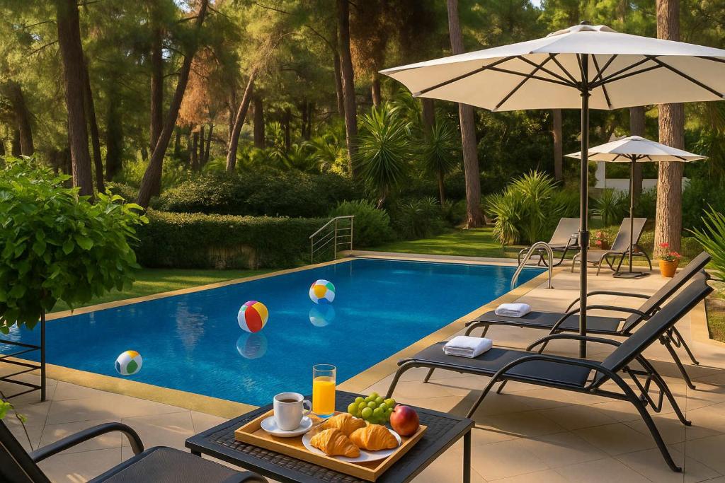 una mesa con un plato de comida junto a una piscina en Hera's Resort with Private Pool and Lush Garden, en Sani Beach