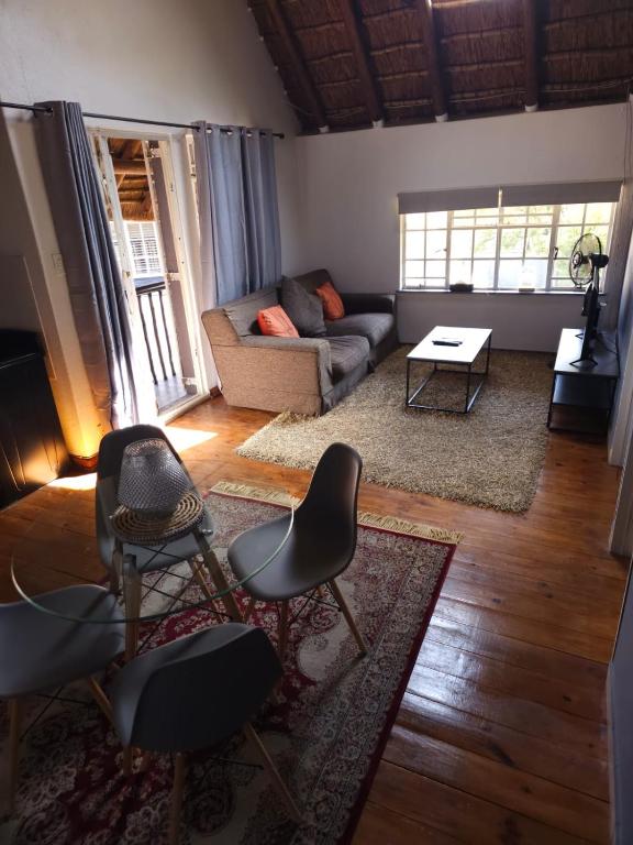 a living room with a couch and chairs at Charming Loft-Style Appartment in Sandton