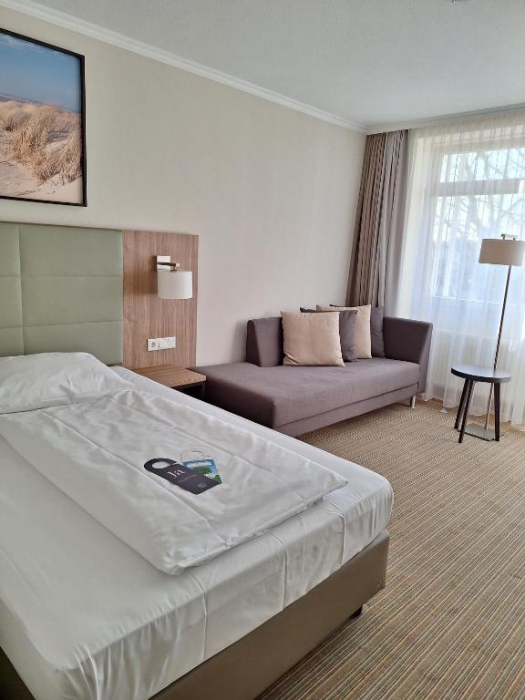 Postel nebo postele na pokoji v ubytování Upstalsboom Parkhotel