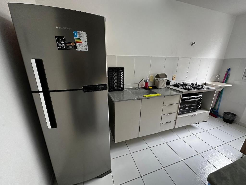 a kitchen with a stainless steel refrigerator in at Ap da Thay - Os Três Pandeiros in Campina Grande