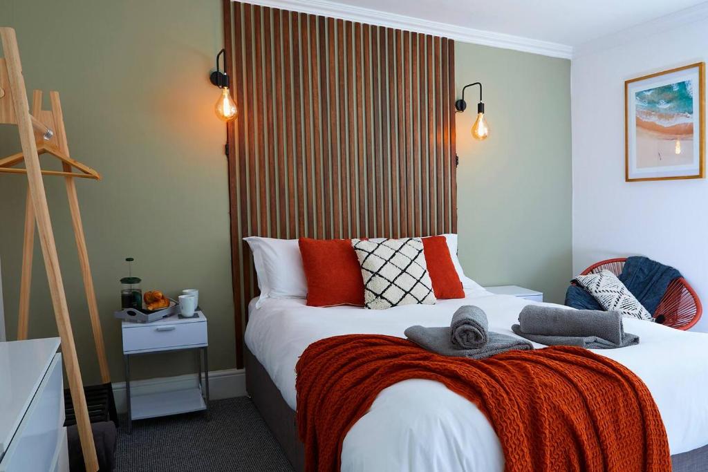a bedroom with a bed with a red blanket on it at The Court Yard Apartment - Fantastic location! in Scarborough