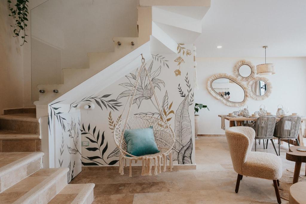 a living room with a staircase with a blue pillow at Casa Reina Tulum in Tulum